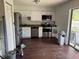 Open kitchen area with stainless steel appliances, white cabinets and sliding glass door leading to the outside at 6308 Stanwin Dr, Apopka, FL 32712