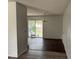 A bright living room space with dark wood-look floors and large sliding glass doors leading to backyard at 6308 Stanwin Dr, Apopka, FL 32712