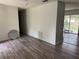 Living room with wood-look flooring and white walls, transitioning into another room, and natural light at 6308 Stanwin Dr, Apopka, FL 32712