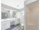 Clean bathroom featuring double vanity, walk-in shower, and modern fixtures at 6740 Odoniel W Loop, Lakeland, FL 33809