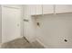 Functional laundry room features white cabinets above a new washer/dryer hookup at 6740 Odoniel W Loop, Lakeland, FL 33809