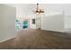 Spacious living room with vaulted ceilings, ceiling fan, large arched windows and neutral carpeting at 6740 Odoniel W Loop, Lakeland, FL 33809