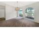 Bright living room features a pendant light fixture and arched windows overlooking the front yard at 6740 Odoniel W Loop, Lakeland, FL 33809
