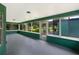 Enclosed sunroom with a gray floor, many large windows and neutral green wall paint at 6740 Odoniel W Loop, Lakeland, FL 33809