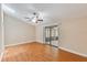 Bright bedroom with wood floors, ceiling fan, and sliding doors to a screened patio at 7263 Spring Villas Cir, Orlando, FL 32819