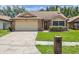 Charming one-story brick home with a well-manicured lawn and a two-car garage at 7263 Spring Villas Cir, Orlando, FL 32819