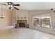 Spacious living room with tile flooring, fireplace, and large windows overlooking the backyard at 7263 Spring Villas Cir, Orlando, FL 32819