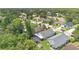Wide aerial view of a home in a lush, green neighborhood with a creek and enclosed patio at 7809 Altavan Ave, Orlando, FL 32822