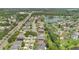 An aerial view of a neighborhood showcasing well-maintained homes, green spaces, and a picturesque pond at 7809 Altavan Ave, Orlando, FL 32822