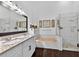 Bright bathroom with double vanity, soaking tub, and glass-enclosed shower at 7809 Altavan Ave, Orlando, FL 32822