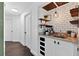Elegant coffee bar with granite countertops, subway tile backsplash, and decorative shelving for a modern and inviting space at 7809 Altavan Ave, Orlando, FL 32822