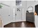 Welcoming entryway with hardwood floors and a decorative storage cabinet at 7809 Altavan Ave, Orlando, FL 32822