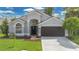 Charming single-Gathering home with well-maintained landscaping, a two-car garage, and a welcoming front entrance at 7809 Altavan Ave, Orlando, FL 32822