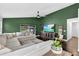 Comfortable living area features a large green accent wall and ample seating at 7809 Altavan Ave, Orlando, FL 32822