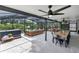 Spacious screened patio with ceiling fans, dining area, and lounge seating at 7809 Altavan Ave, Orlando, FL 32822