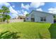Spacious backyard featuring a well-manicured lawn and privacy fence, perfect for outdoor activities at 7952 Oakstone Ct, Orlando, FL 32822