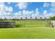 Backyard featuring lush grass, mature trees, and a fenced perimeter, offering privacy and outdoor enjoyment at 7952 Oakstone Ct, Orlando, FL 32822