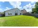 Backyard featuring lush grass, mature trees, and a fenced perimeter, offering privacy and outdoor enjoyment at 7952 Oakstone Ct, Orlando, FL 32822