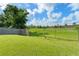 Backyard featuring lush grass, mature trees, and a fenced perimeter, offering privacy and outdoor enjoyment at 7952 Oakstone Ct, Orlando, FL 32822