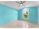 Bright bedroom with tile flooring and a large window, providing plenty of natural light at 7952 Oakstone Ct, Orlando, FL 32822