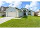Charming single-story home featuring a two-car garage and well-manicured lawn at 7952 Oakstone Ct, Orlando, FL 32822