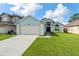 Charming home with a two-car garage, well-maintained lawn, and inviting entryway at 7952 Oakstone Ct, Orlando, FL 32822