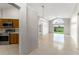 Bright, open-concept living room with tiled floors and large slider that provides outdoor view at 7952 Oakstone Ct, Orlando, FL 32822