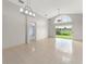 Bright, open-concept living room with tiled floors and large slider that provides outdoor view at 7952 Oakstone Ct, Orlando, FL 32822