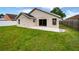 Large, well-maintained backyard with a concrete patio and a wood fence at 8994 Fort Jefferson Blvd, Orlando, FL 32822