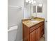 This bathroom features a vanity with granite countertop, a sink and a mirror at 8994 Fort Jefferson Blvd, Orlando, FL 32822