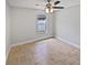 Neutral bedroom featuring a large window and tiled floors at 8994 Fort Jefferson Blvd, Orlando, FL 32822