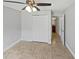 Bedroom with neutral walls, tile flooring, double closet, a ceiling fan and access to the bathroom at 8994 Fort Jefferson Blvd, Orlando, FL 32822