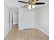 This bedroom features neutral walls, tile flooring, a ceiling fan and a closet with double doors at 8994 Fort Jefferson Blvd, Orlando, FL 32822