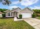 Charming single-story home featuring a well-maintained lawn and a two-car garage at 8994 Fort Jefferson Blvd, Orlando, FL 32822