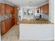 Well-lit kitchen with granite countertops, stainless steel appliances, and wooden cabinetry at 8994 Fort Jefferson Blvd, Orlando, FL 32822