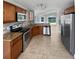 Modern kitchen featuring stainless steel appliances, granite countertops, and wood cabinets at 8994 Fort Jefferson Blvd, Orlando, FL 32822