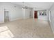 Spacious living room with tile flooring and a ceiling fan, open to the kitchen area at 8994 Fort Jefferson Blvd, Orlando, FL 32822
