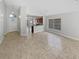 Open-concept living space with tile flooring, showcasing the front door and kitchen at 8994 Fort Jefferson Blvd, Orlando, FL 32822