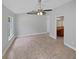 Main bedroom featuring a ceiling fan, tile floors, and access to the en-suite bathroom at 8994 Fort Jefferson Blvd, Orlando, FL 32822
