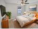 Cozy bedroom with a wood frame bed, neutral tones, and a bright window at 8994 Fort Jefferson Blvd, Orlando, FL 32822