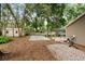 Large backyard with mature trees, volleyball area, patio, and storage shed at 917 Southern Oak Ln, Apopka, FL 32712