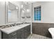 Bathroom featuring dual sinks, decorative mirrors, and a textured glass block window at 917 Southern Oak Ln, Apopka, FL 32712