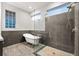 Chic bathroom features a glass enclosed shower, a standalone tub and modern fixtures at 917 Southern Oak Ln, Apopka, FL 32712