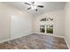 Light-filled bedroom with stylish wood-look flooring, and a shiplap accent wall at 917 Southern Oak Ln, Apopka, FL 32712