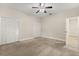 Spacious bedroom featuring neutral walls, plush carpeting, and a ceiling fan at 917 Southern Oak Ln, Apopka, FL 32712