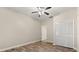 Bedroom featuring wood-look tile floors, a ceiling fan, and a closet with louvered doors at 917 Southern Oak Ln, Apopka, FL 32712