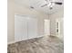 Bedroom featuring wood-look floors, ample closet space and neutral colored walls at 917 Southern Oak Ln, Apopka, FL 32712