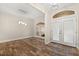 Open-concept dining room with modern chandelier and beautiful wood-look tile flooring at 917 Southern Oak Ln, Apopka, FL 32712
