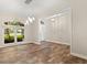 Bright dining area with wood-look tile floors, modern chandelier and large window at 917 Southern Oak Ln, Apopka, FL 32712