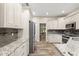 Kitchen featuring stainless steel appliances, granite countertops, and white cabinets at 917 Southern Oak Ln, Apopka, FL 32712